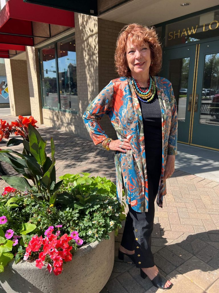 Accessories with a flair...and hair - Greeley's women's clothing boutique stylish clothing - woman in colorful jacket