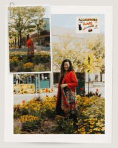 How can I style accessories to make my fall wardrobe stand out? - Accessories with a Flair and Hair - photo of a woman standing amongst sunflowers wearing a fall colored cardigan